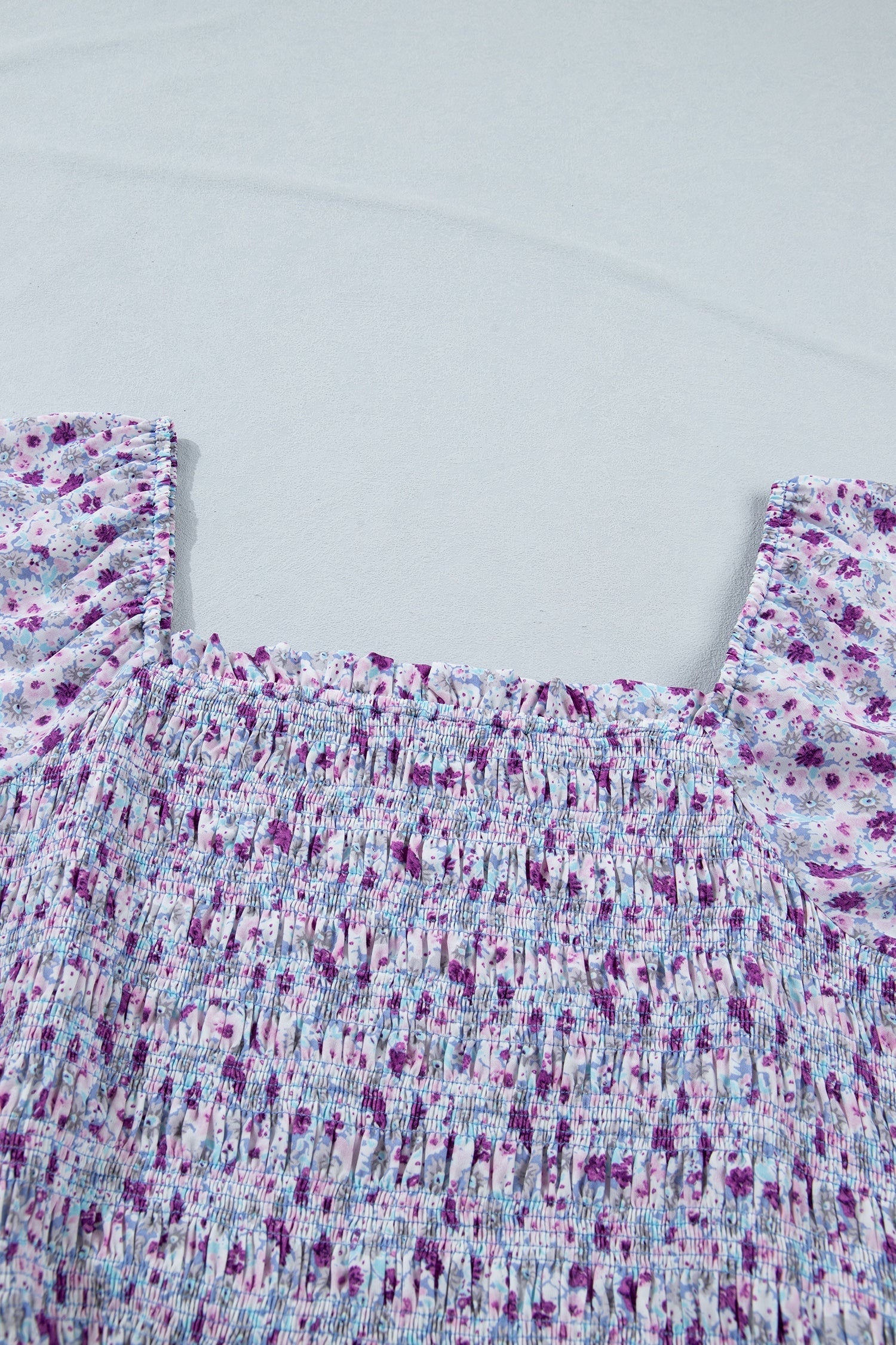 Purple floral smocked bodice with square neckline and gathered tiered skirt detail