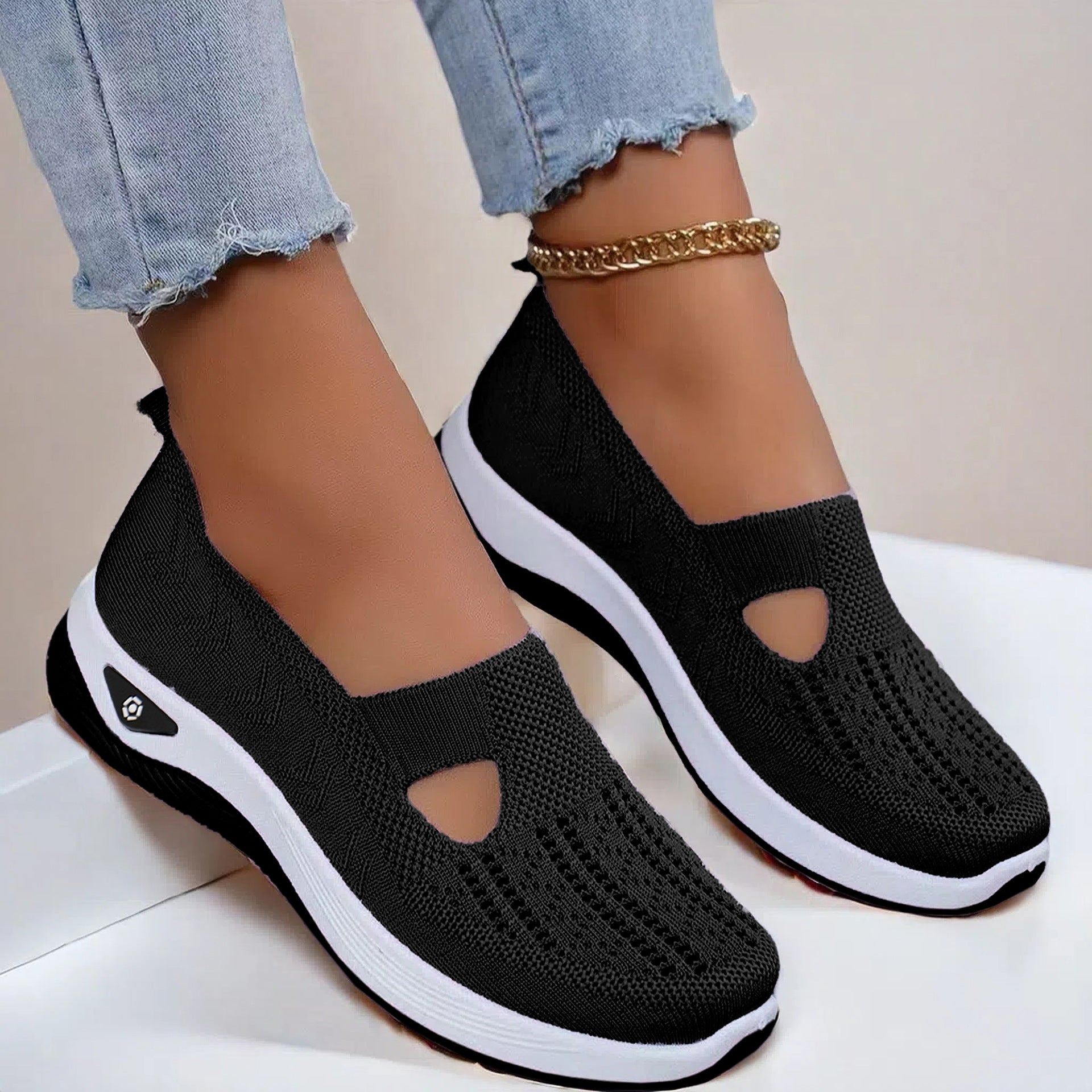 Black knit mesh flats with oval cutout and white sole, slip-on casual shoes