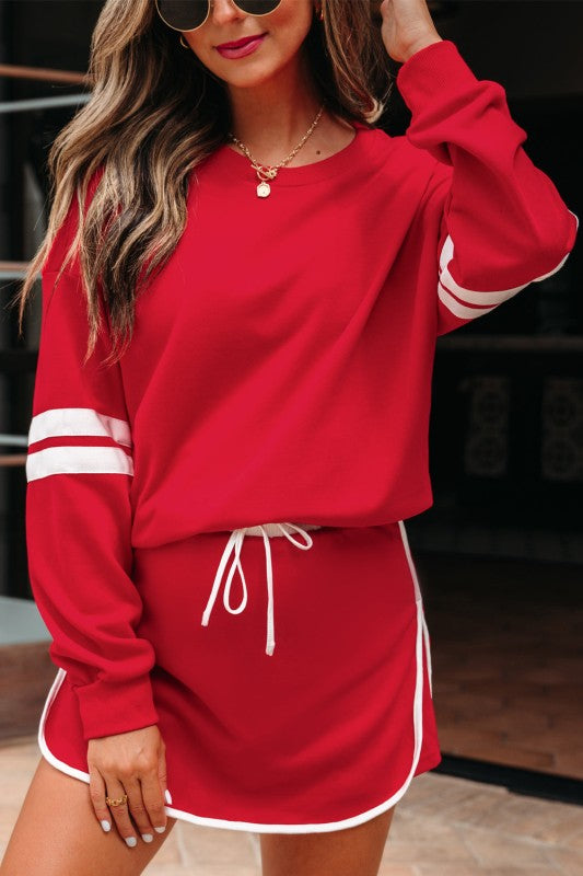 Red pullover sweatshirt and mini skirt set with white striped cuffs and drawstring waist