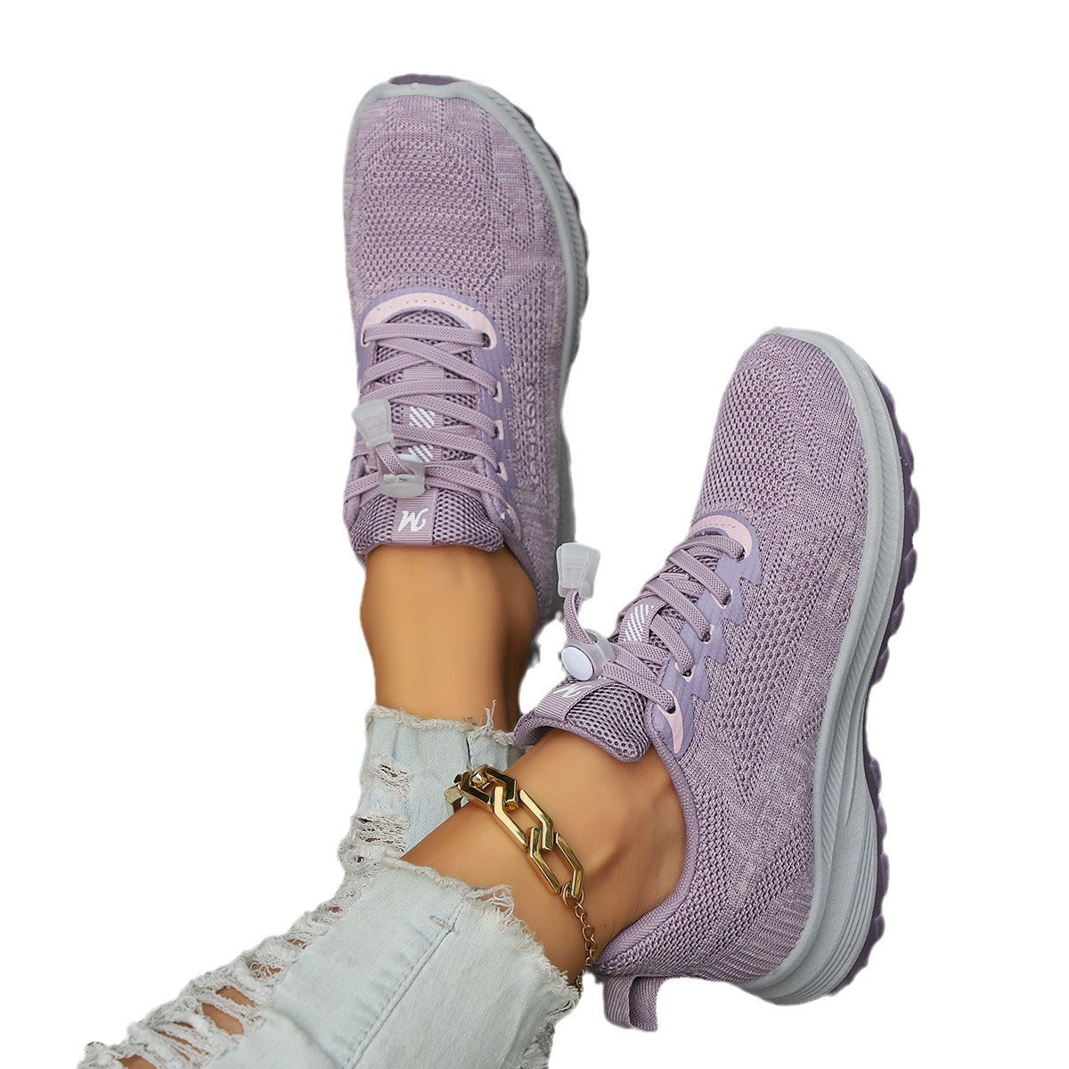 Lavender knit lace-up travel shoes with thick gray sole and padded collar