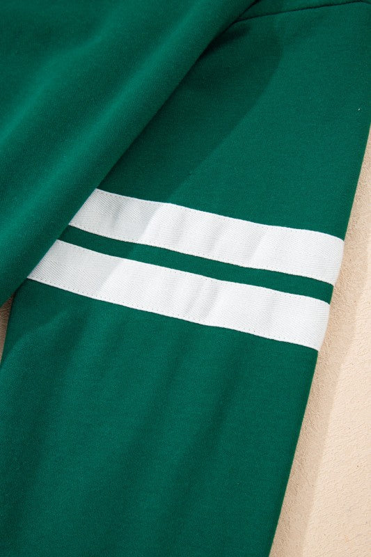 Green sleeve with white varsity stripe band