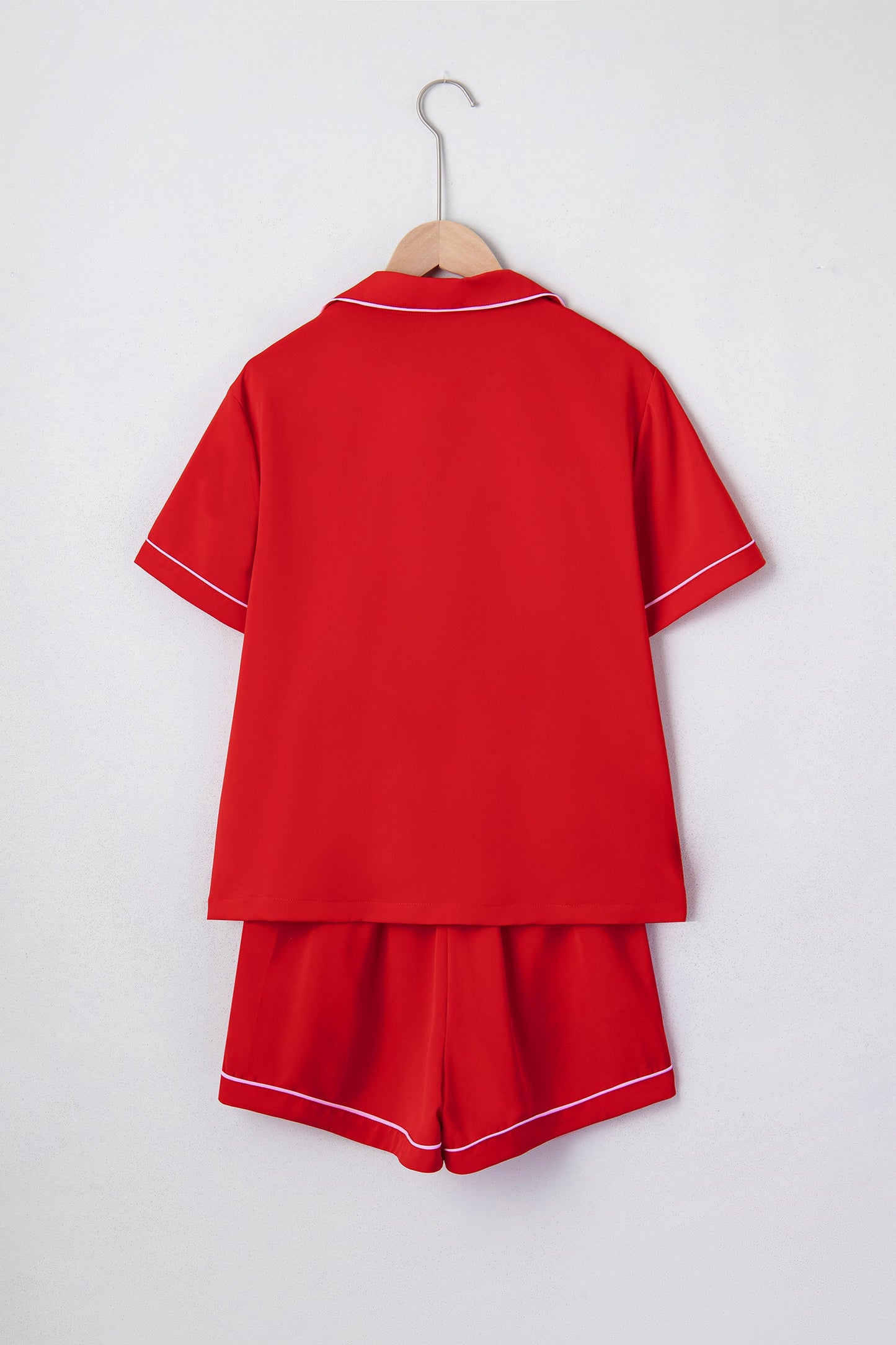 Red silky pajama set back view on hanger with short sleeves and matching shorts