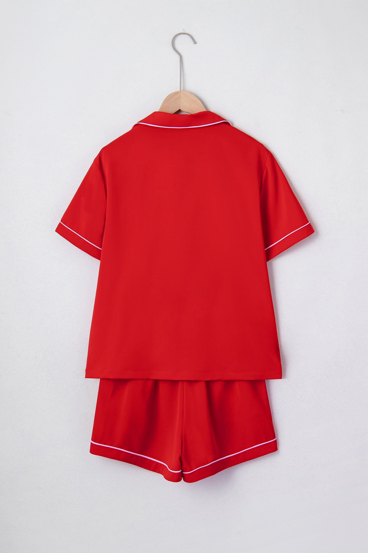 Red silky pajama set back view on hanger with short sleeves and matching shorts