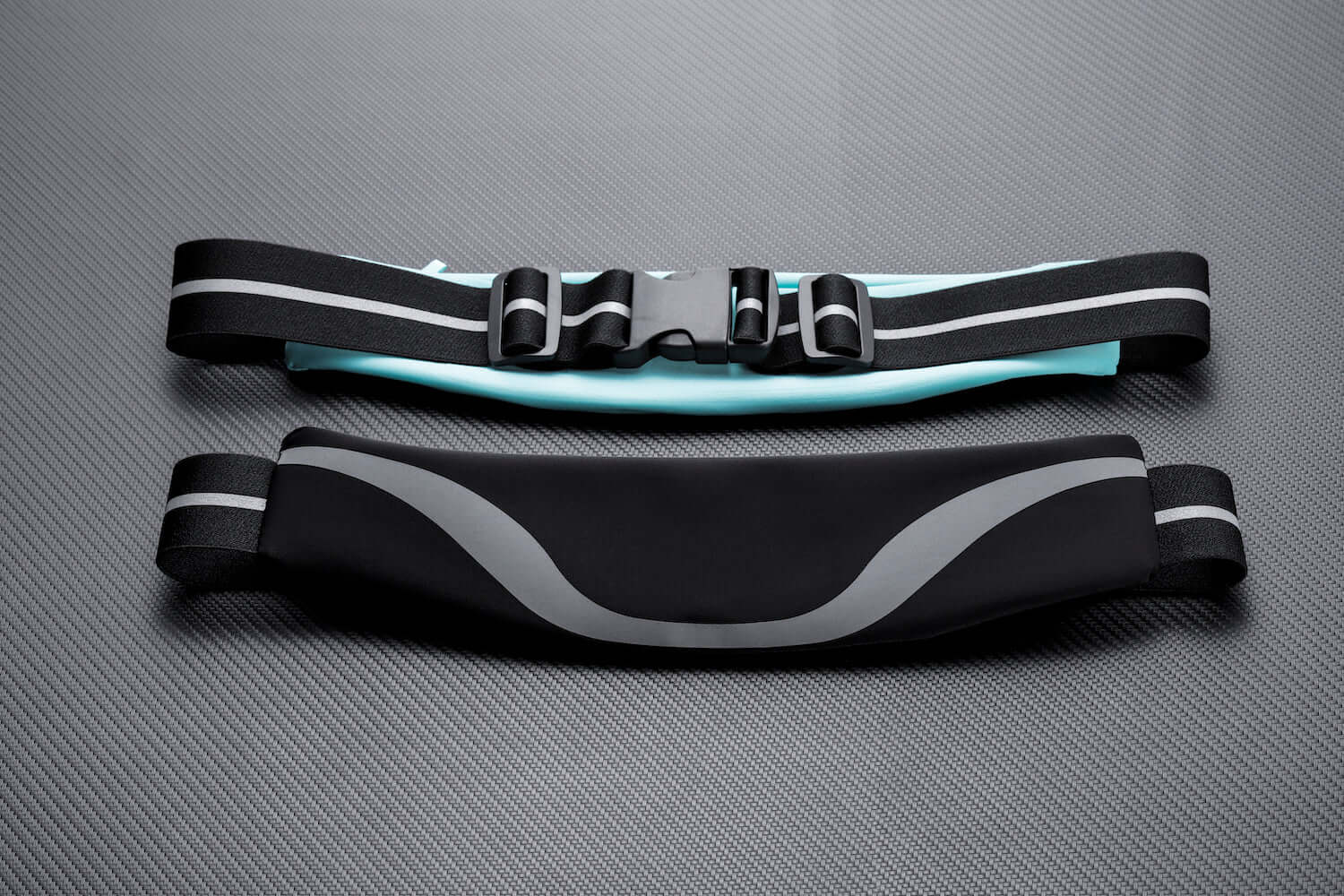 Water-resistant sport waist pack running belt with black and gray reflective stripe and adjustable strap.