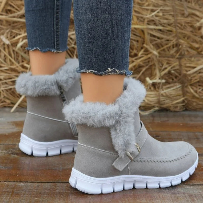 Grey ankle snow boots with plush fur lining, side zipper, buckle strap, chunky white sole