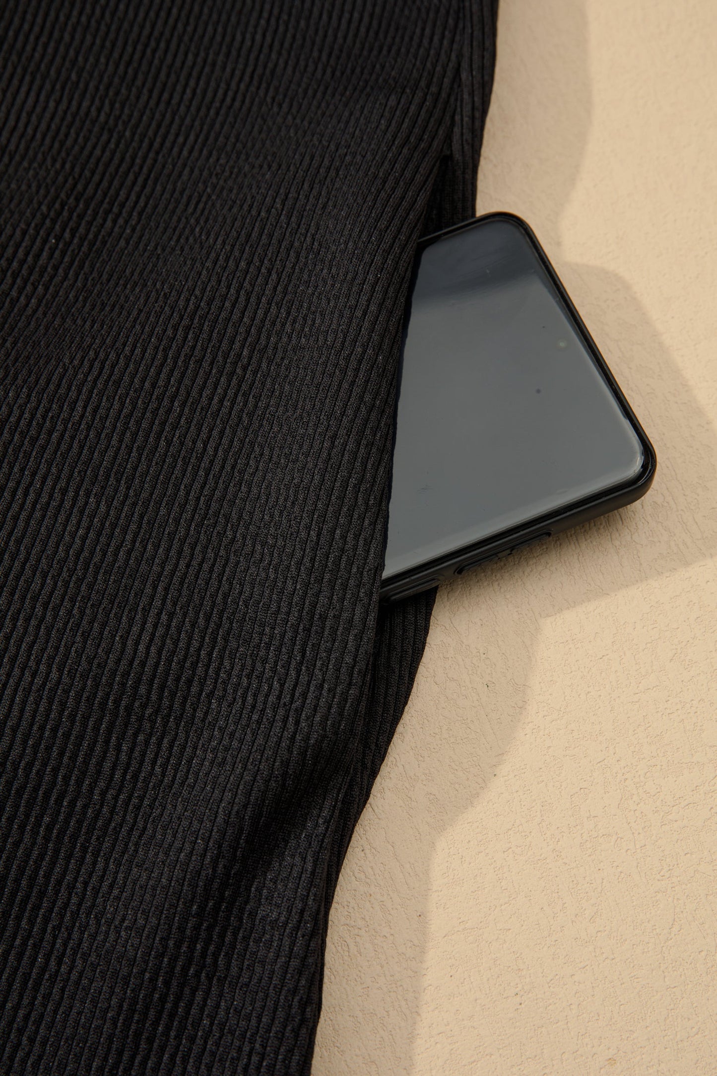 Black ribbed fabric with subtle seam line detail