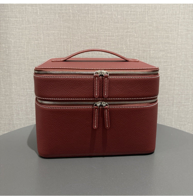 Brick red leather-look jewelry storage tote with double zippers and top handle