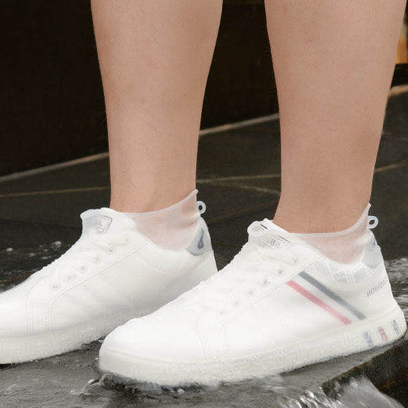White waterproof shoe covers extending to the ankle, thick non-slip textured sole