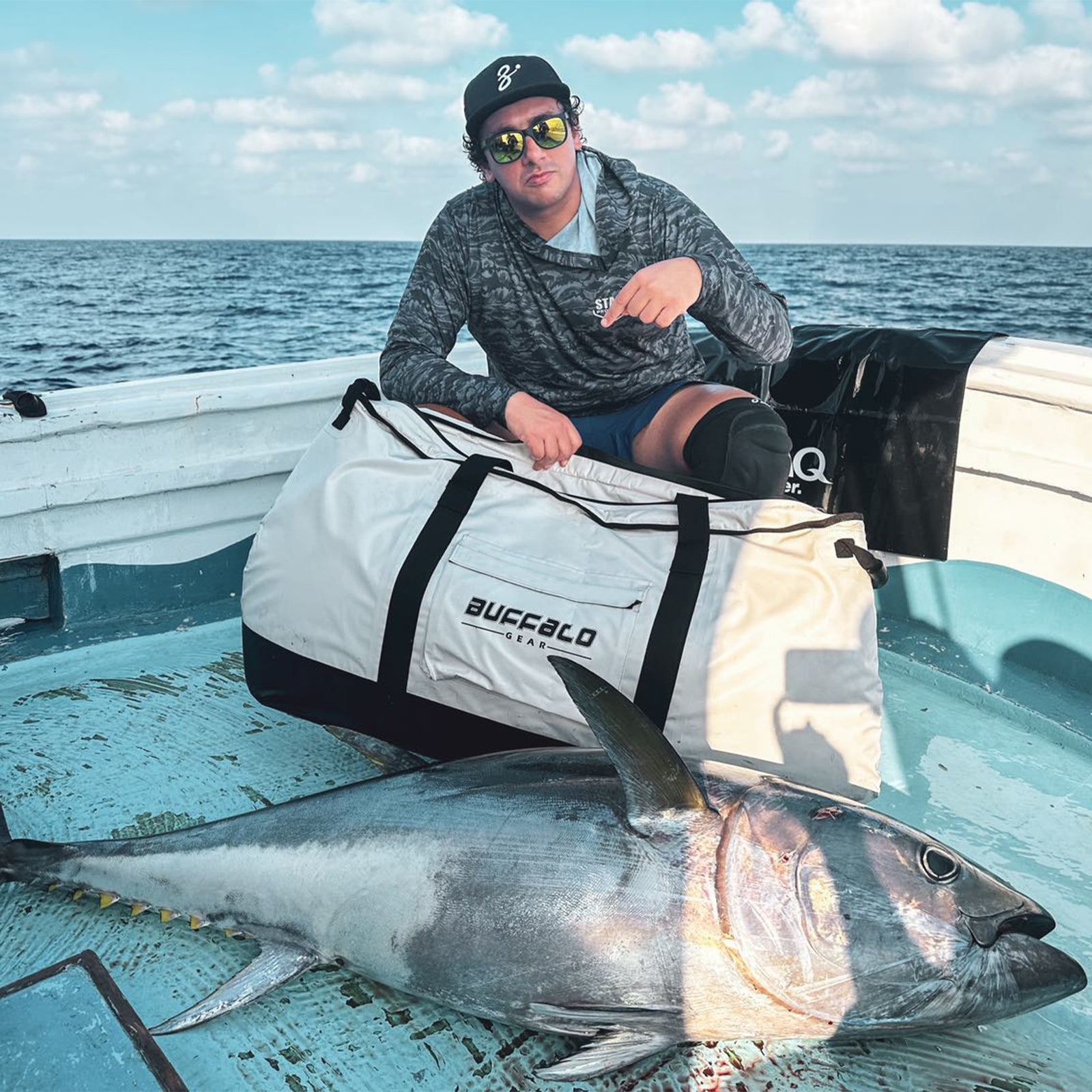 White fish cooler bag with black straps and front logo patch