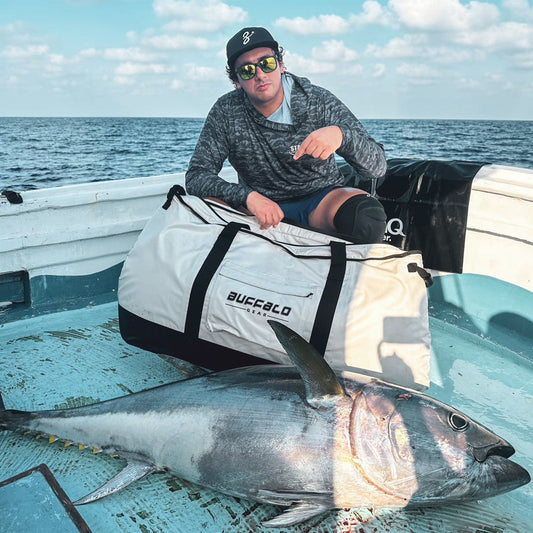 White fish cooler bag with black straps and front logo patch