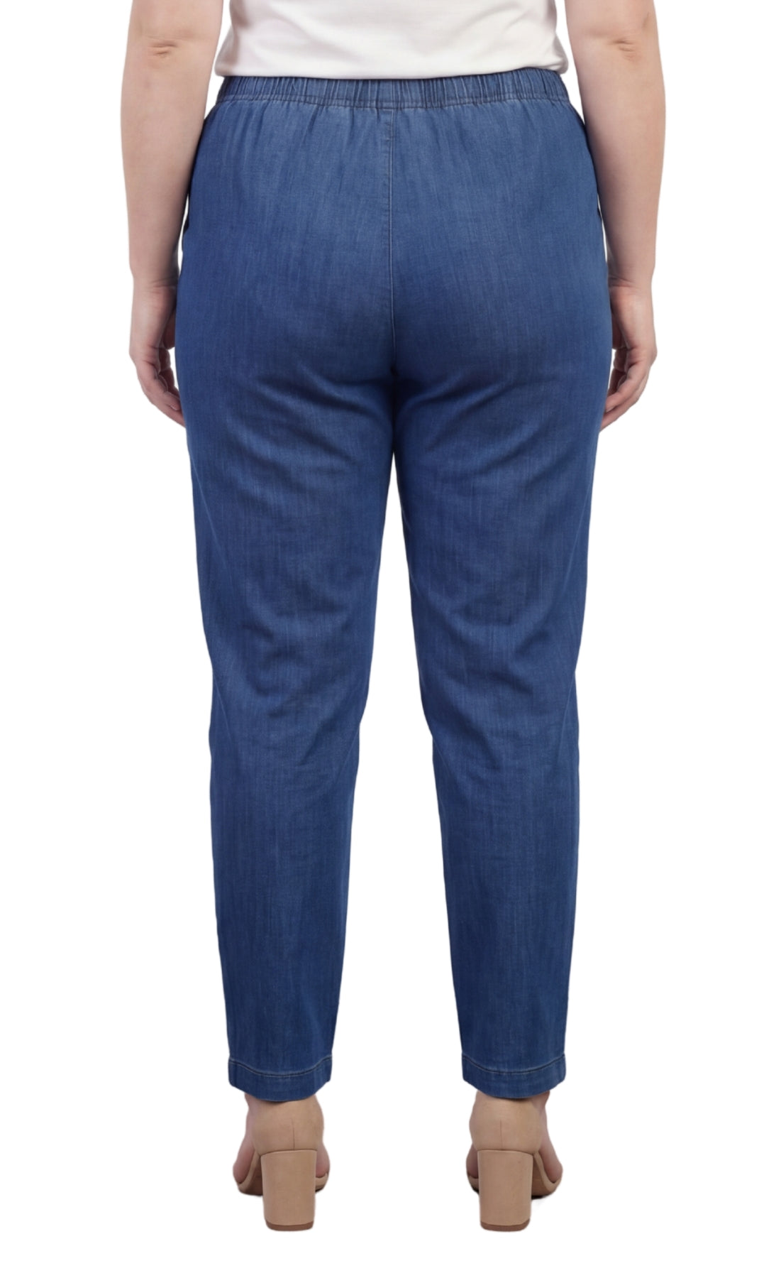Blue denim pants worn by a person on a white background