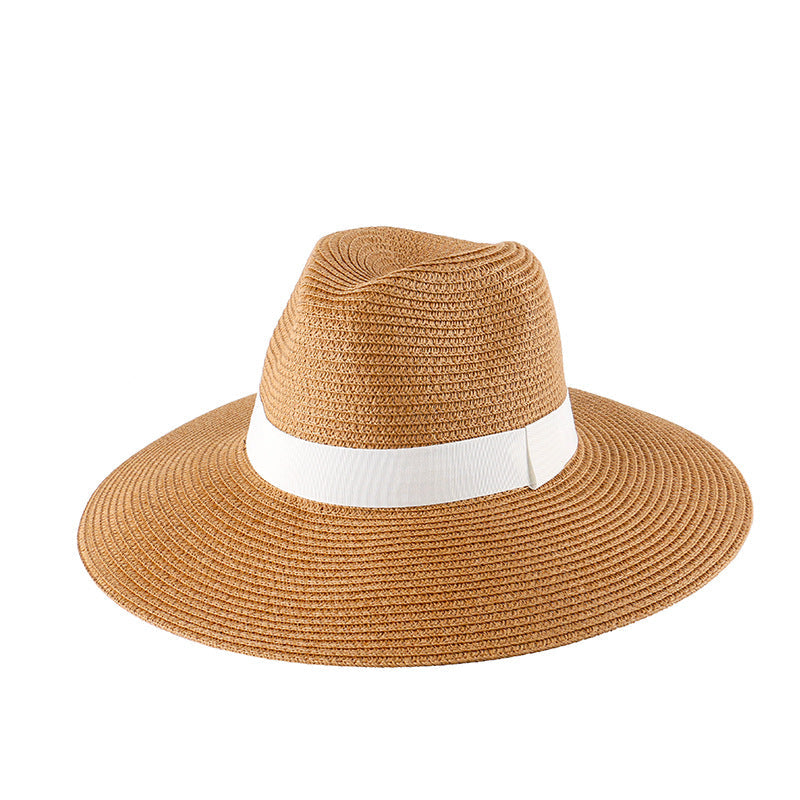Khaki straw wide-brim fedora sun hat with white band, angled view