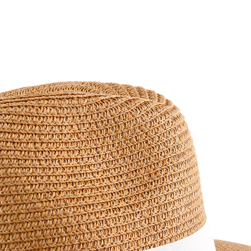 Khaki straw hat crown detail with textured weave and white band