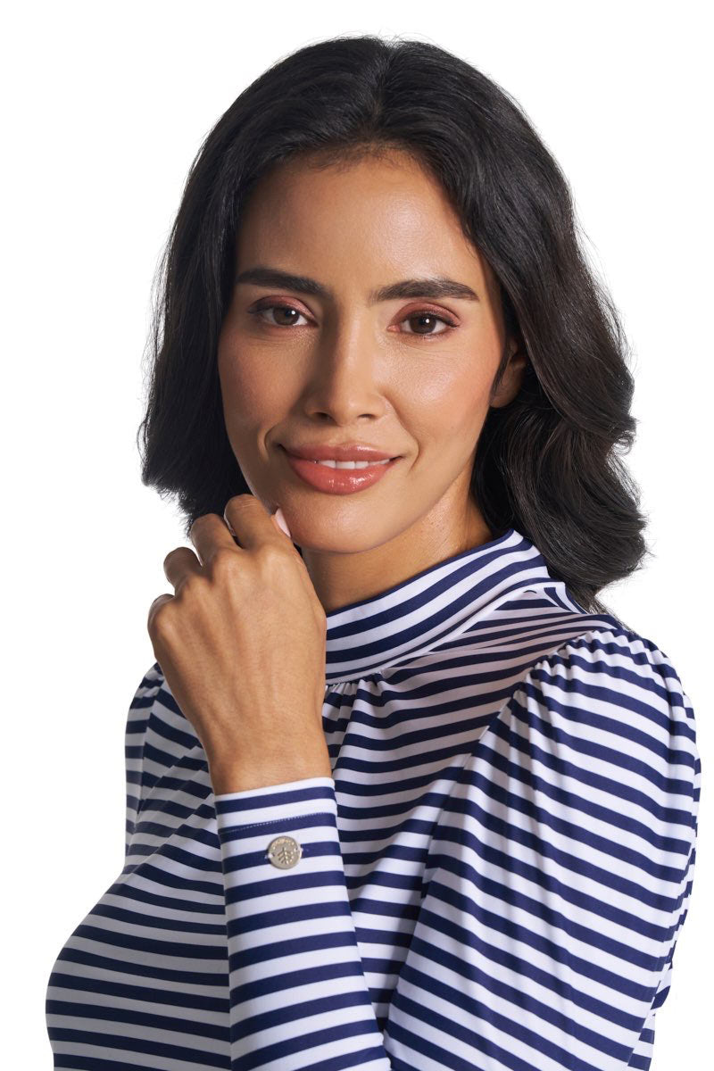 High-neck navy-and-white striped swim top with puff sleeves and logo on cuff