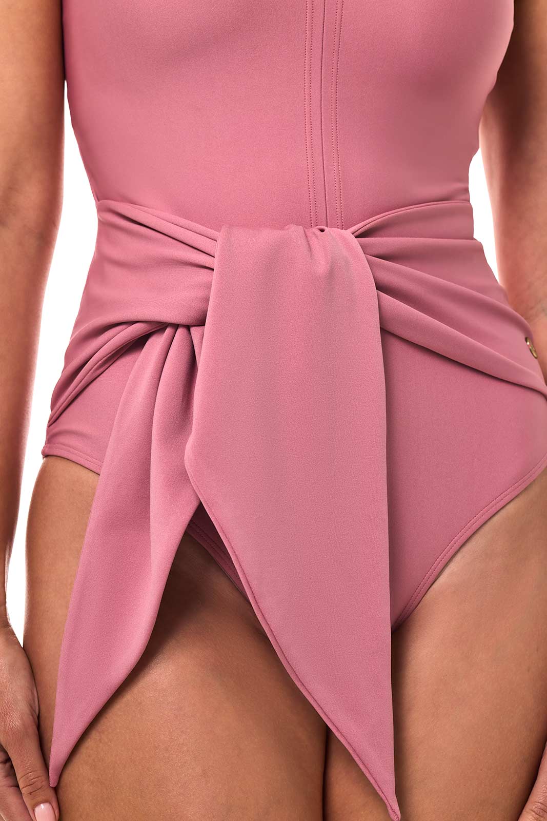 Close-up of mauve pink wrap waist with gathered bow and asymmetrical drape panels