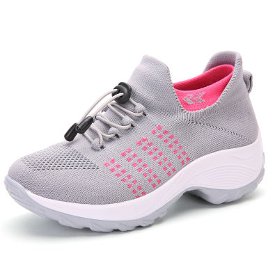 Light gray knit athletic sneaker with pink accents, lace-up and white cushioned sole