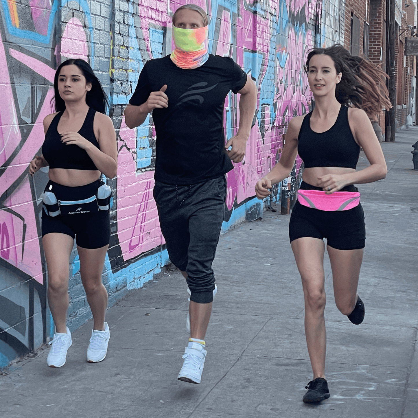 Water-resistant sport waist pack with bright pink reflective stripe, worn around the waist.