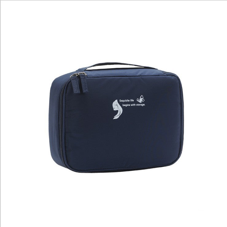 Navy blue square waterproof makeup/toiletry bag with zippered top and handle.