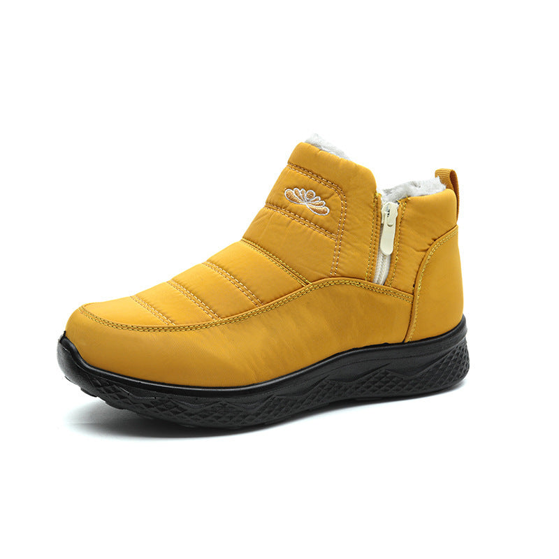 Women’s yellow ankle snow boots with faux-fur cuff and front zipper closure