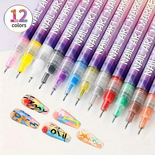 Twelve clear-capped nail art marker pens with colored ink tips arranged in rows