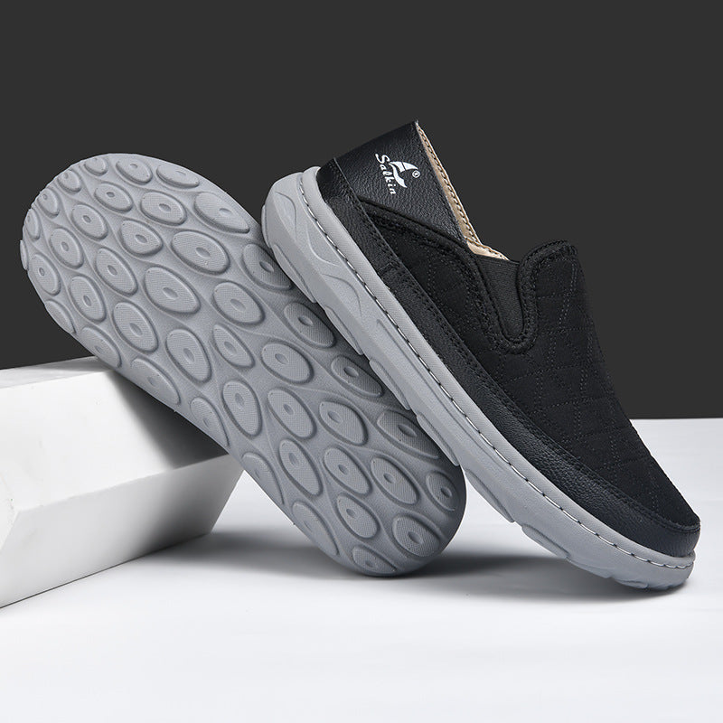 Men's casual travel shoes outsole view, black upper with gray tread sole and stitching