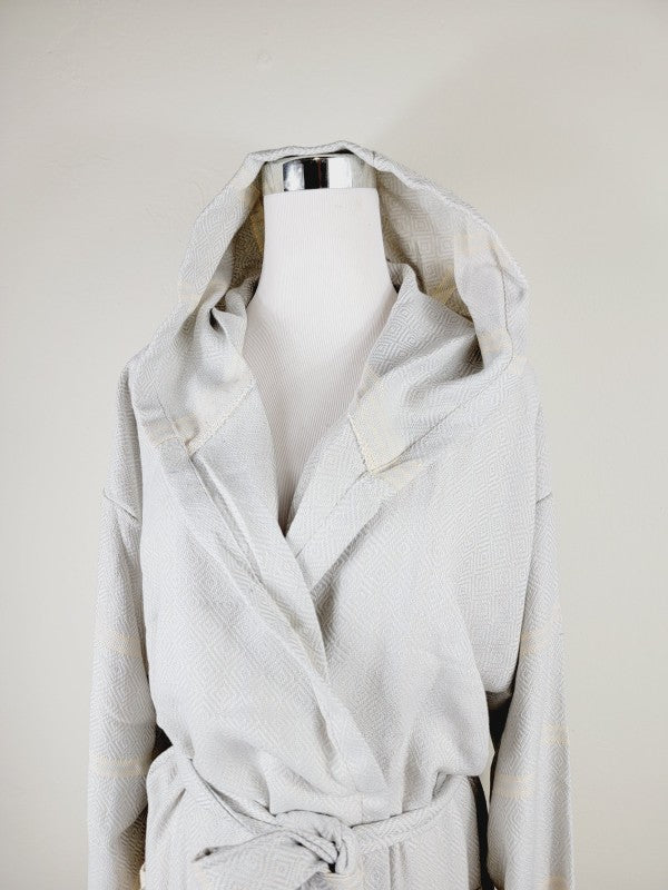 Light white hooded robe with wrap front, tie belt, and long sleeves