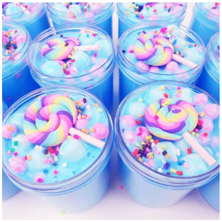 Blue slime jars with rainbow lollipop swirls, sticks, and sprinkle confetti