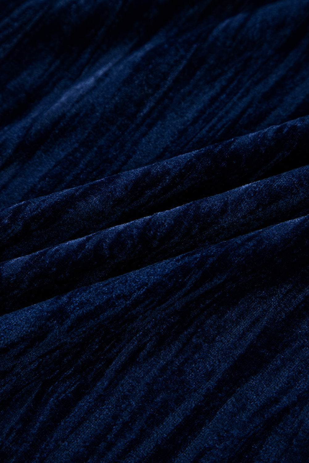 Close-up of navy blue textured fabric with subtle vertical shimmer lines