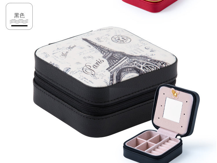 Black jewelry organizer case with printed lid, hinged mirror, zipper, and ring compartments