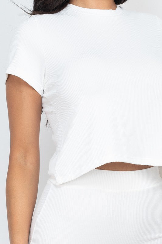 Ribbed white crop top and midi skirt set close-up, short sleeves and matching texture.