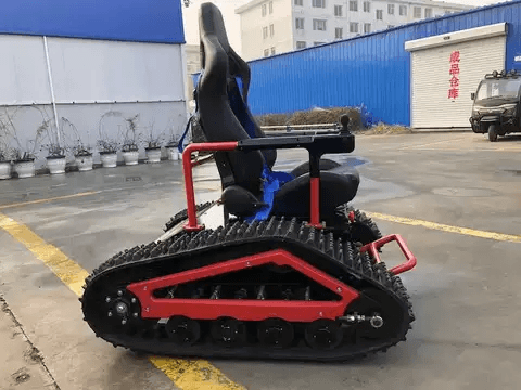 All-terrain electric wheelchair with blue seat, red frame, and large tread tracks