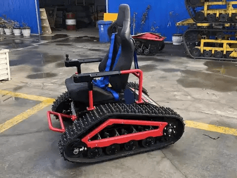 Red electric all-terrain wheelchair with front control bar and treaded track base