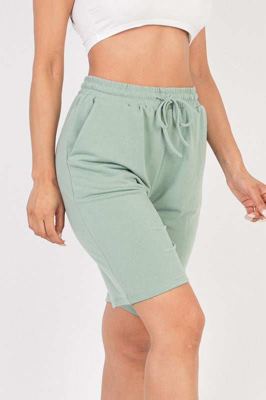 French terry bermuda shorts in mint green with elastic waistband and tied drawstring