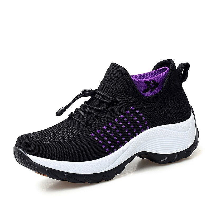 Women’s athletic knit sneaker in black with purple dotted pattern and white sole