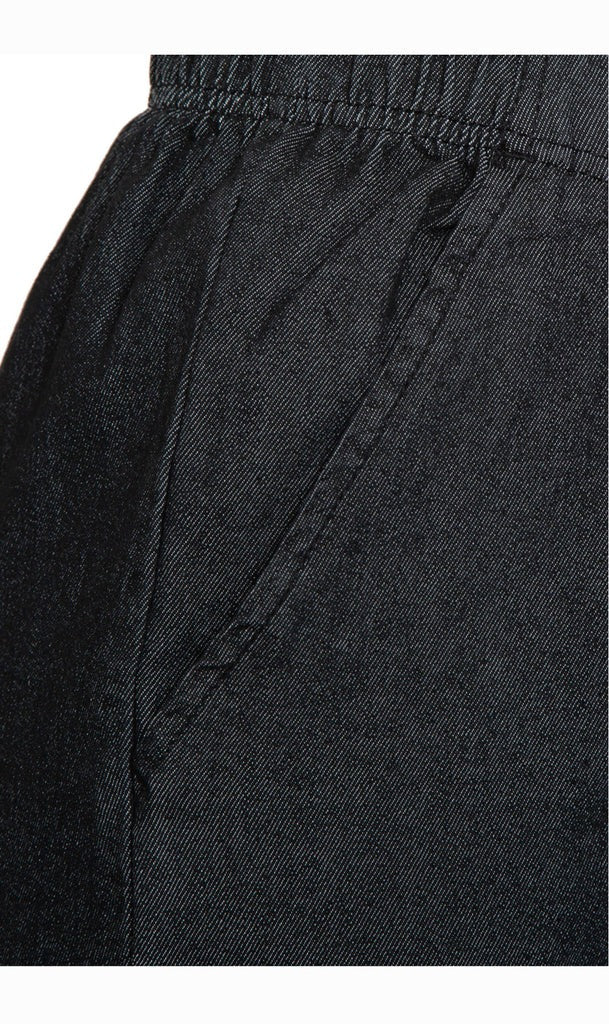 Close-up of black pants with a focus on the waistband and fabric texture.