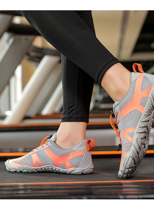 Gray hiking shoes with orange accents, lace-up closure, and grippy tread outsole