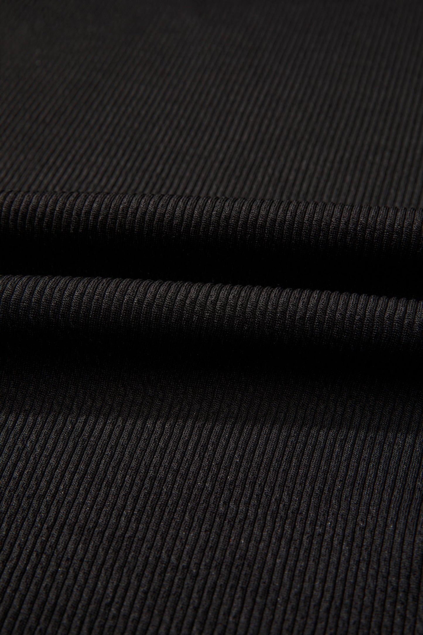 Black ribbed fabric with horizontal seam and layered construction
