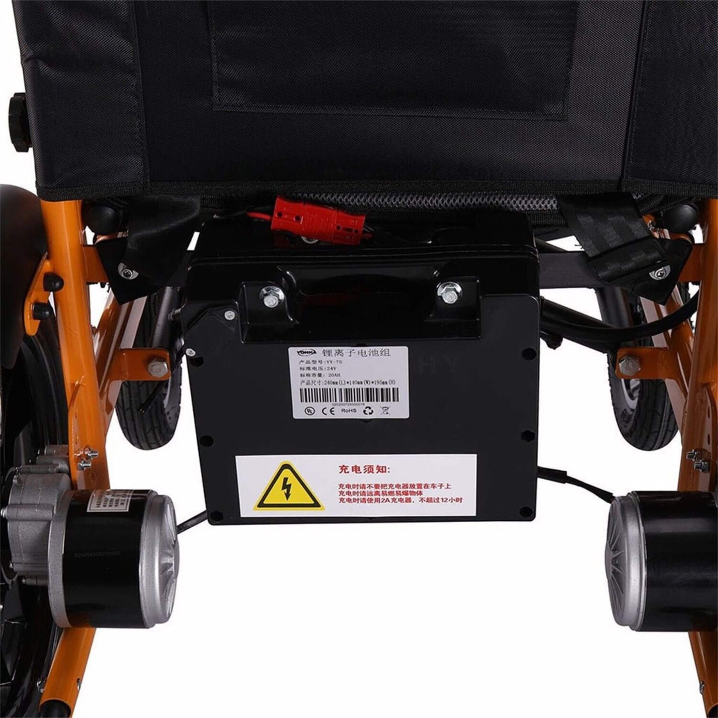 Under-seat battery housing and wiring on orange electric wheelchair frame, warning label