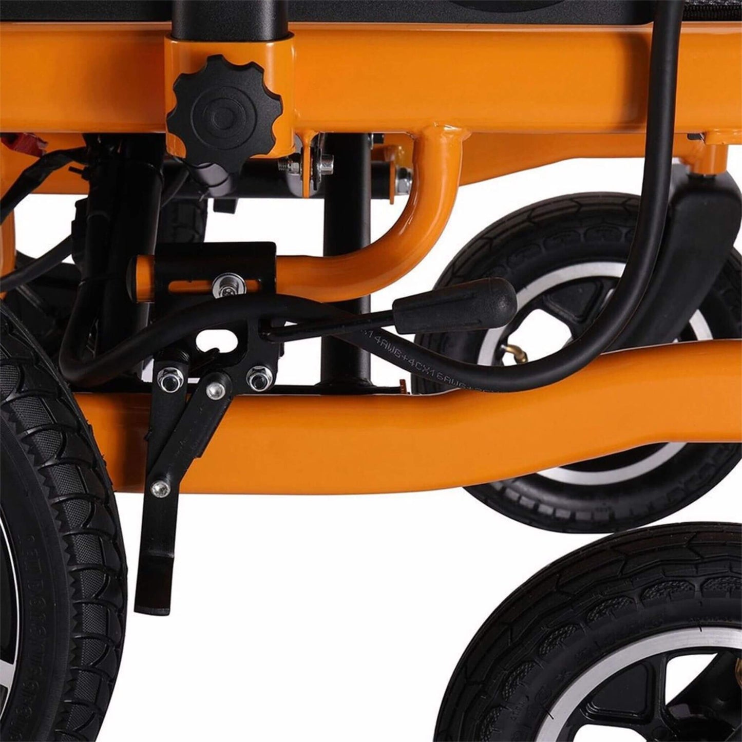 Close-up of orange wheelchair frame near front wheel, black cables and brackets