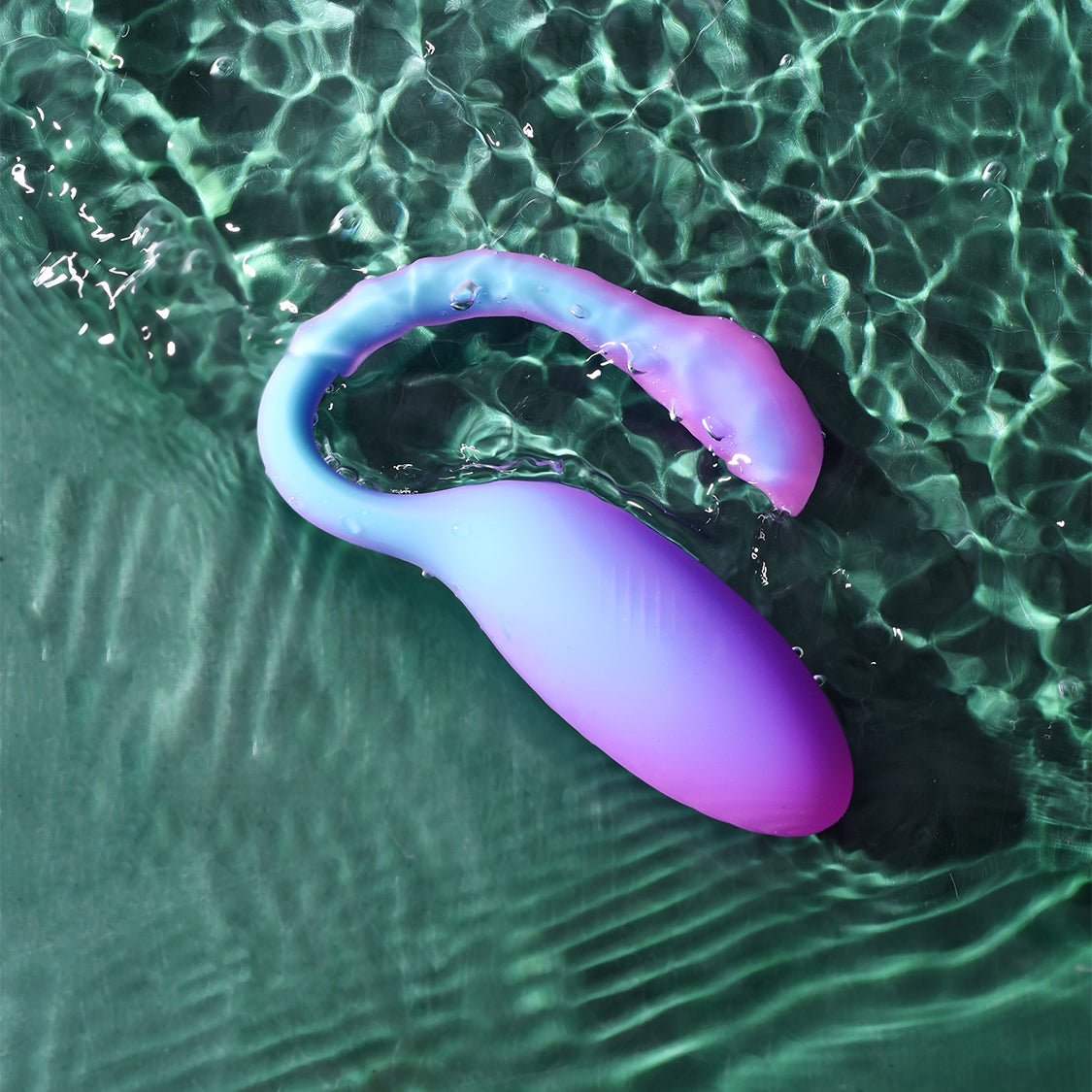 Purple and blue flamingo-shaped vibrating toy in water