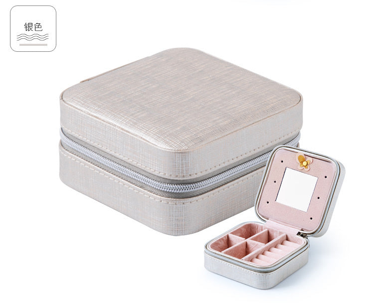 Silver/gray jewelry organizer case with hinged mirror, zipper, and divided ring compartments