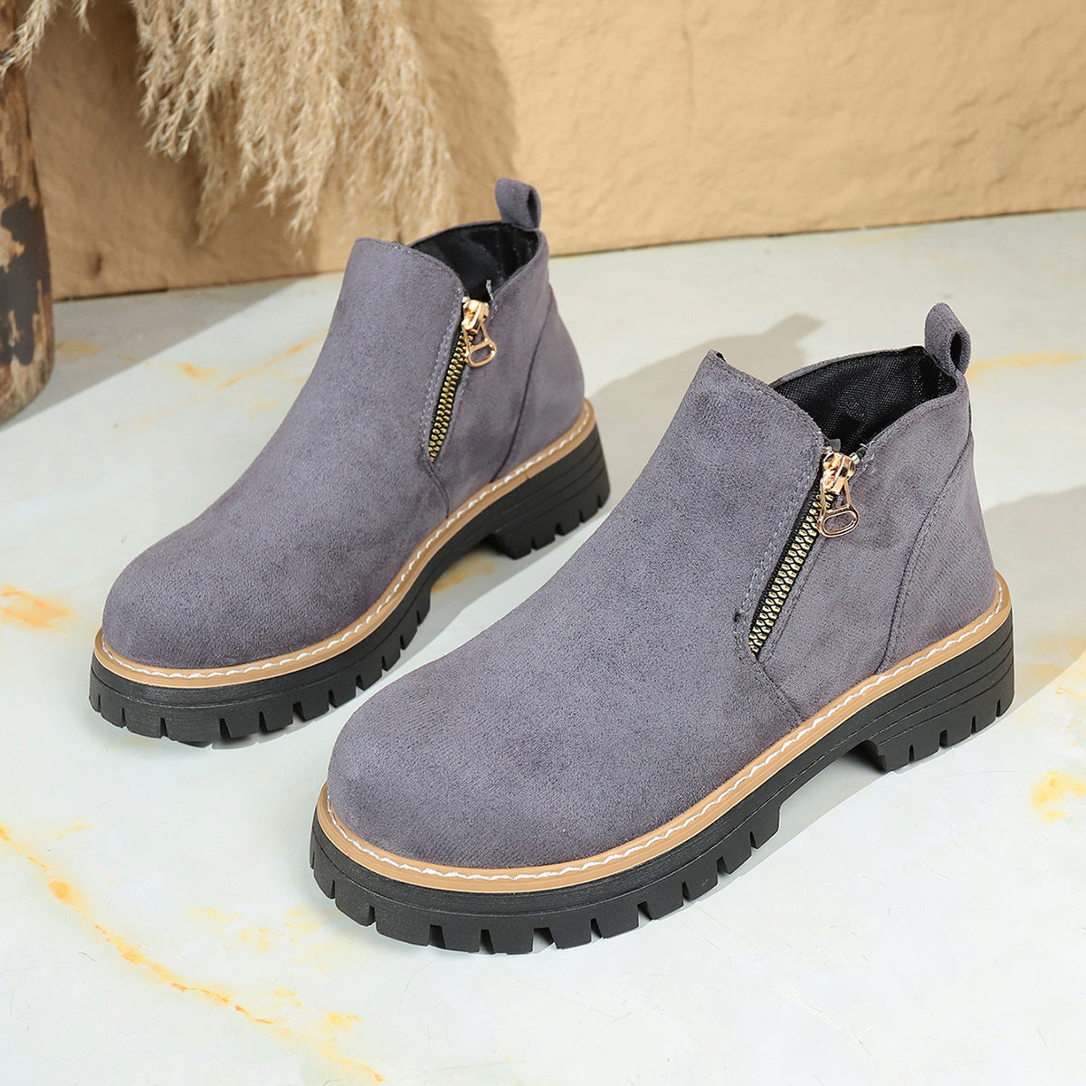 Grey suede ankle boots with side zipper and chunky lug sole