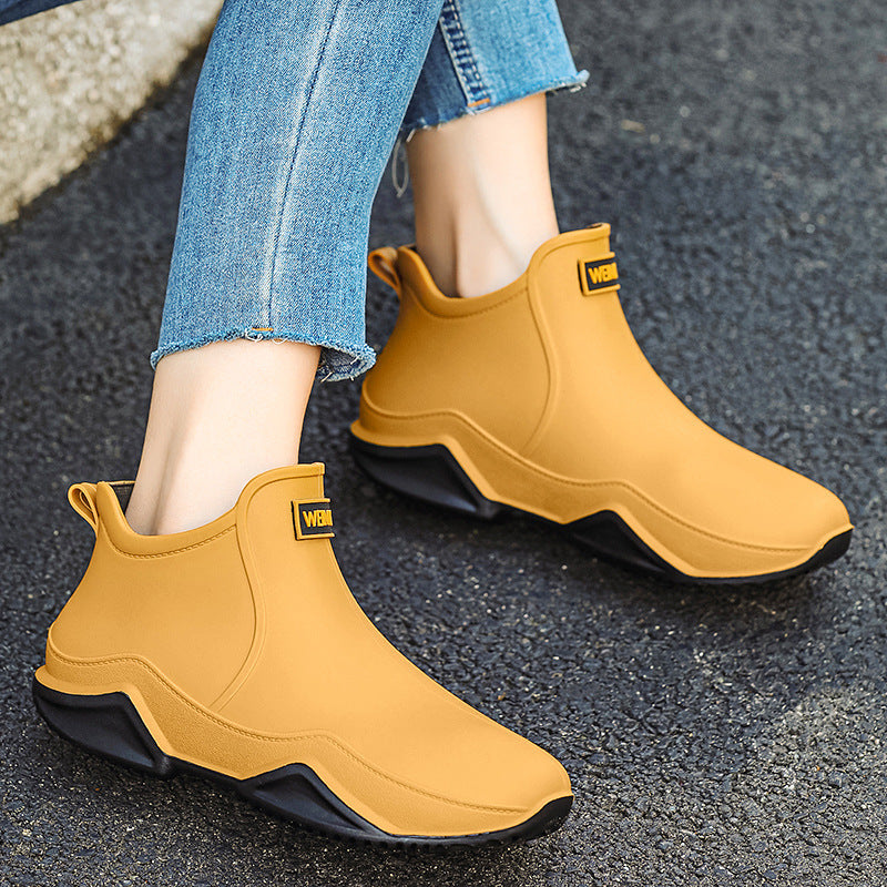 Men's short rain boots in mustard tan with dark outsole and logo patch