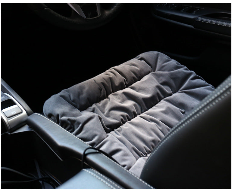 Grey heating pad insert on car seat with padded fabric and control cord