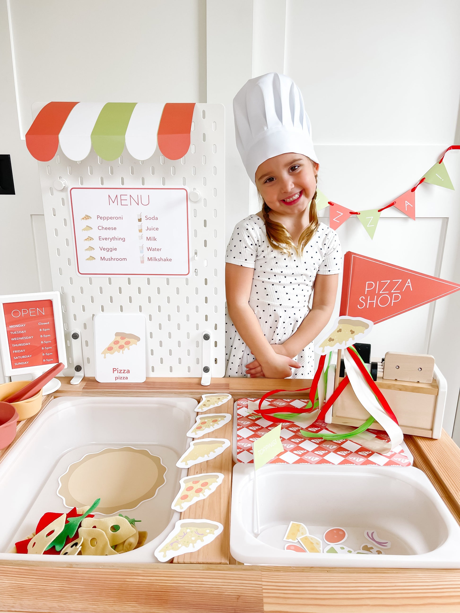 Pizza shop play kit with menu board, pizza shop sign, and stacked pretend food cutouts