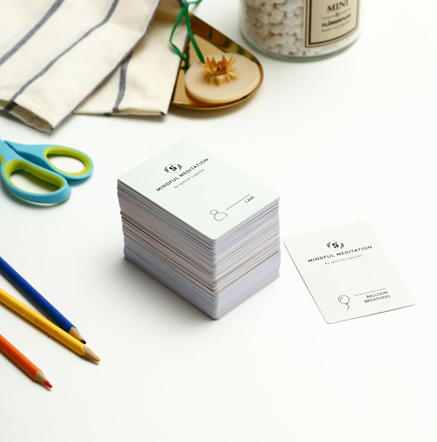Mindfulness meditation cards, stacked with card backs in white and light purple.