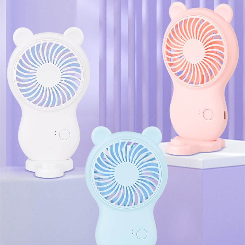 White handheld pocket mini fan with round grille, bear ears, standing base, and power button