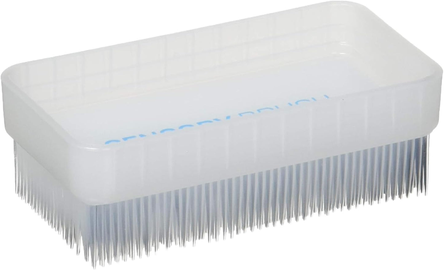 Rectangular therapy brush with dense white bristles on one flat side