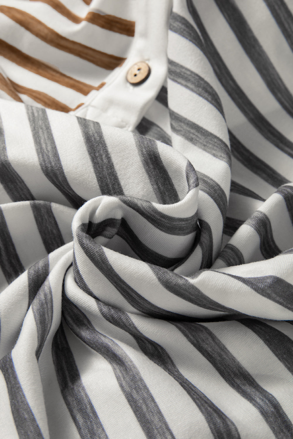 Gray-striped sleeveless jumpsuit with white button band and draped fabric detail
