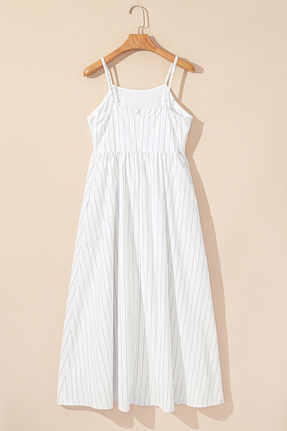 White pinstripe spaghetti-strap maxi dress on hanger, open-back scoop neck